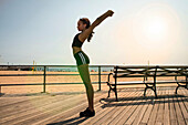 Runner stretching on wooden pier