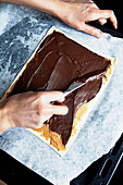 Woman making cake with chocolate spread