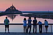 France, Normandy Region, Manche Department, Mont St-Michel, Le Barrage du Mont Saint Michel dam, dusk, silhouettes of people, NR