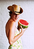 Woman in Cowboy Hat Holding Watermelon