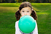 Young Girl Inflating a Balloon, Toronto, Ontario