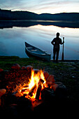Silhouette of a Woman Holding a Paddle beside a Canoe, Lac Laurel, Quebec