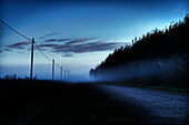 A foggy summer morning on a country road north of Edmonton, Alberta.