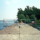 Naked Man Jumping through Fence by Lake