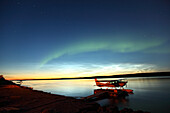 Aurora borealis over the MacKenzie River with float planes in foreground, Fort Simpson, Northwest Territories