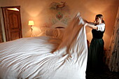 France, Rhone Alps, Megève Ski Resort, Chalet du Mont d'Arbois - Relais & Châteaux luxury hotel, Bedroom and cleaning woman