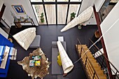 France, Charente-Maritime, Île de Ré, Inside of a modern house, view from above of the living room, zebra skin rug and sofas