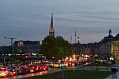 France, Bordeaux, Southwestern France, Aquitaine, Quai de la Douane, road traffic at dusk, St Michel's Church in the background
