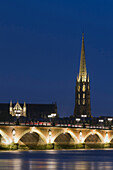 France, Bordeaux, Southwestern France, Aquitaine,   Illuminated Stone bridge, St Michel's Church in the background