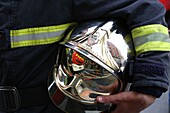 Firefighter carrying his helmet Paris. France.