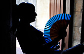woman holding fan in Havana, Cuba