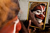 'Africa, Gabon, Estuaire region, Libreville capital, La Sablière, Moroba prepares for a ceremony putting white clay named ''kaolin'' on his face'