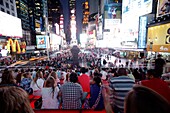 CROWD SITTING ON RED STEPS OF TKTS BOOTH TIMES SQUARE MIDTOWN MANHATTAN NEW YORK CITY USA