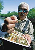 Fisherman Holding Up Various Lures, Agawam Massachusetts Usa