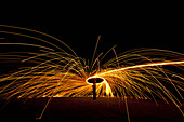 Man Spinning Ball Of Burning Steel Wool At Night, Petersfield, Hampshire, Uk