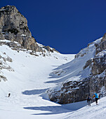 Three backcountry skiers ascending to Monte Pesco Falcone, Rava del Ferro, Maiella, Abruzzo, Italy