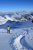Female backcountry skier ascending to Birnhorn, Leoganger Steinberge, Salzburg, Austria