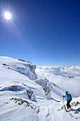 Female backcountry skier ascending to Monte Amaro, Rava della Vespa, Maiella, Abruzzo, Italy