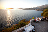 Couple having dinner on the terrace of a restaurant, view over Bay of Budva, Aman Sveti Stefan, Sveti Stefan, Budva, Montenegro