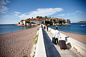 Guests passing isthmus to Aman Sveti Stefan, Sveti Stefan, Budva, Montenegro