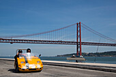 GoCar on the seafront promenade near Ponte 25 de Abril bridge over Tagus river, Lisbon, Lisboa, Portugal