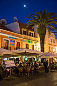 Restaurants with outdoor seating on Praca Costa Pinto square at dusk, Cascais, near Lisbon, Lisboa, Portugal