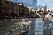 Spiegelung von Gondeln und Gondolieri auf dem Grand Canale in einem Fenster der Vaporetto Haltestelle an der Rialto-Brücke, Venedig, Venetien, Italien