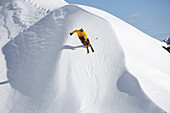 Skifahrer springt über Wechte, Davos, Graubünden, Schweiz