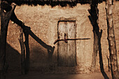 Barred door of an adobe hut, Magadala, Mali