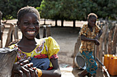Two girls at a well, Magadala, Mali