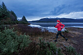 Young woman along Loch Maree, Northwest Highlands in background, Scotland, United Kingdom