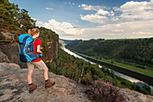 Young woman enjoying view over river Elbe, Saxon Switzerland National Park, Saxony, Germany