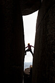 Woman climbing at Cathedral Rock, Mount Buffalo, Australian Alps, Victoria, Australia