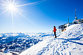Female skier on the top of the Parpaner Rothorn, Lenzerheide, Canton of Graubuenden, Switzerland