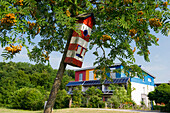 Bird house with passive house in the background, Freiburg im Breisgau, Black Forest, Baden-Würtemberg, Germany