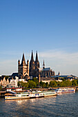 Paddle steamer Goethe on the Rhine river in front of Cologne cathedral and Gross-Sankt-Martin church, Cologne, Rhine river, North Rhine-Westphalia, Germany