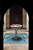 Flowers in water fountain in courtyard, Dar Les Cigognes, Marrakech, Morocco