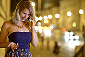 Young woman phoning with a mobile phone, Munich, Upper Bavaria, Bavaria, Germany