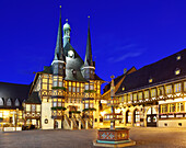 View over market square to illuminated town hall, Wernigerode, Saxony-Anhalt, Germany