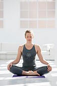 Healthy young woman doing the auspicious pose yoga position