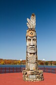 Wood craving of Indian totem pole at lakeside in Wakefield, Michigan, USA