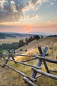 Classic log fence in ranch lands of Granite County Montana at sunset