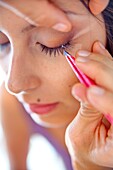 Woman during eye lashes extensions