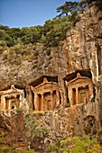 The Hellenistic temple fronted Tombs of Kaunos, 4th - 2nd cent  B C, just outside the archaeological site of Kounos on the oposite side of the Calbys river from Dalyan, Turkey  Kaunos is on the border of Lycia & Caria and the Kaunos rock tombs differ sli