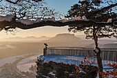 View from the spectacular rock formation Bastei (Bastion) in the national park Saxony Switzerland to the health resort Rathen (Oberrathen) near Dresden. In the background is the Table Mountain Lilienstein. He is one of the most striking mountains in the E