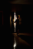 Boy Looking in Refrigerator in Dark Kitchen