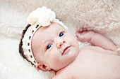Newborn Baby With Knitted Headband Looking Up, Portrait