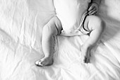 Newborn Baby's Legs on Bed, High Angle View
