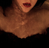 Young Woman Submerged in Water With Lips Above Water, High Angle View, Close-Up