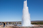 Tourists Watching Strokkur, The Emblematic Geyser Of The Geysir Site, Region Of The Golden Circle, Iceland